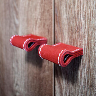 Cabinet handle in red nubuck leather with white stitching Cabinet hardware in red nubuck leather with white stitching