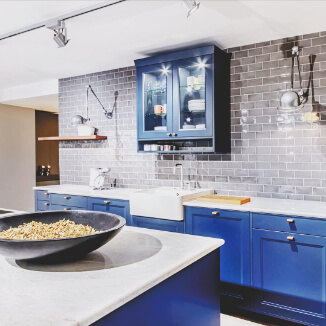 Leather handles at blue kitchen cabinet doors Leather handles at blue kitchen cabinet doors