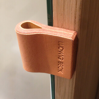 Drawer pull made of leather with logo Drawer pull made of leather with logo