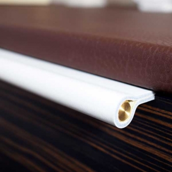 Edge pulls made of white leather and brass