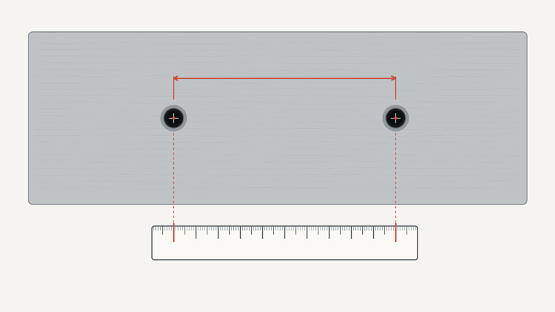 Measuring handle hole spacing from the center of one mounting hole to the center of the other