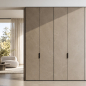 Preview: Full view of tall stone-look cabinet doors with vertically mounted black VERONA handles