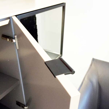 Black VERONA recessed leather pull fitted into the edge of an open cabinet door