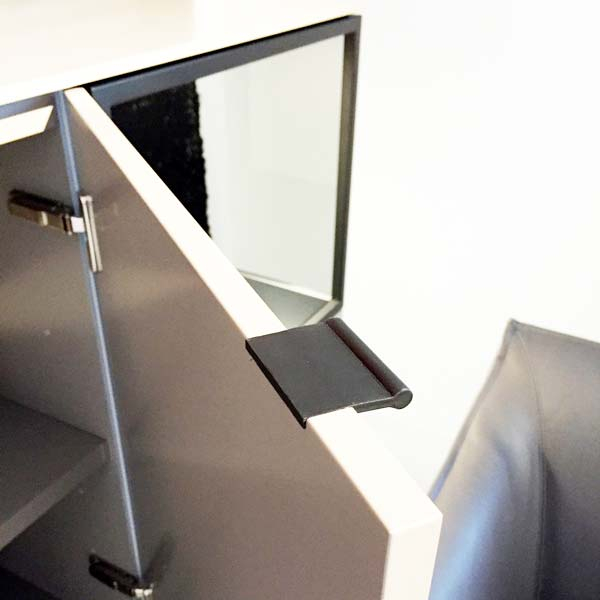 Black VERONA recessed leather pull fitted into the edge of an open cabinet door