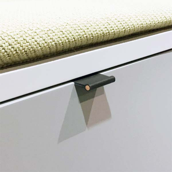 Black VERONA leather handle recessed into the edge of a closed cabinet door