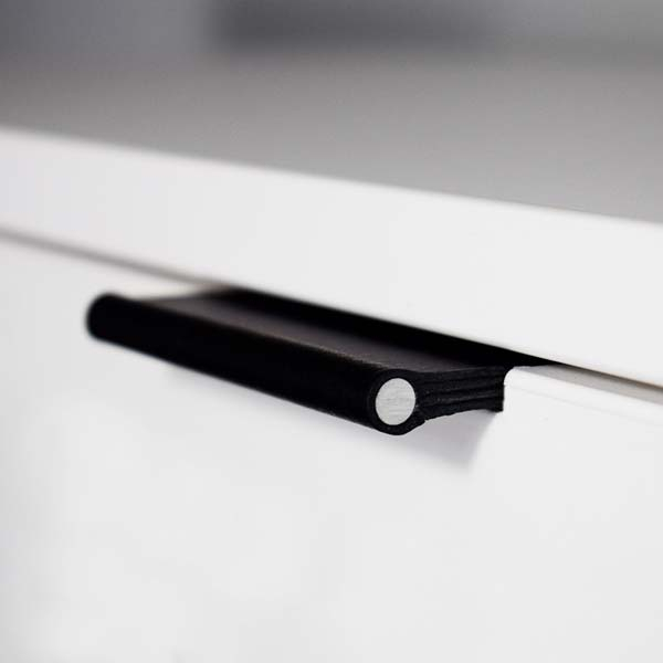 Black VERONA leather handle with aluminum rod recessed into a white furniture front